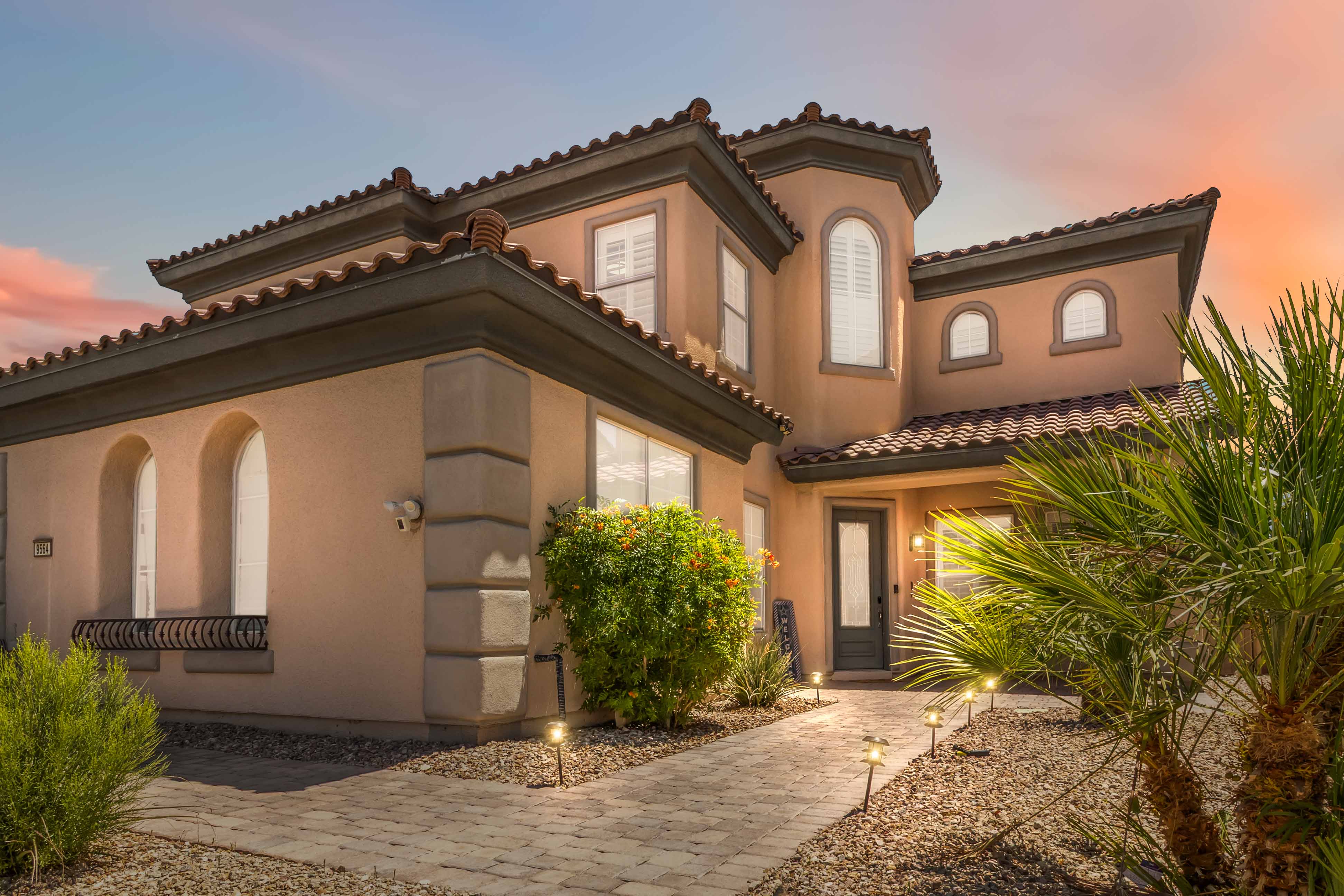 Angled exterior view of 9564 Trattoria Street leading toward the covered front entry