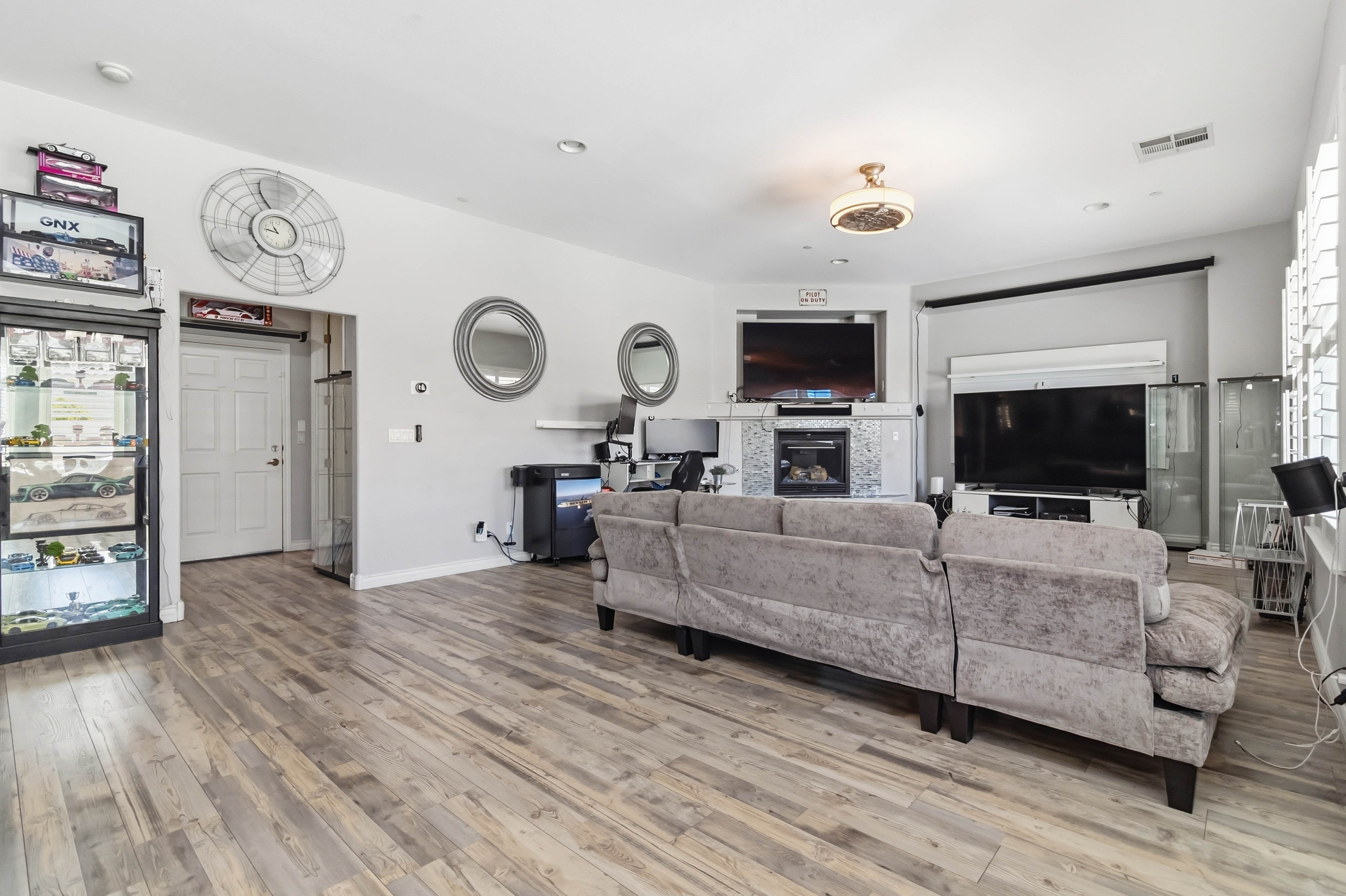 Great room seating area at 9564 Trattoria Street with fireplace and media wall