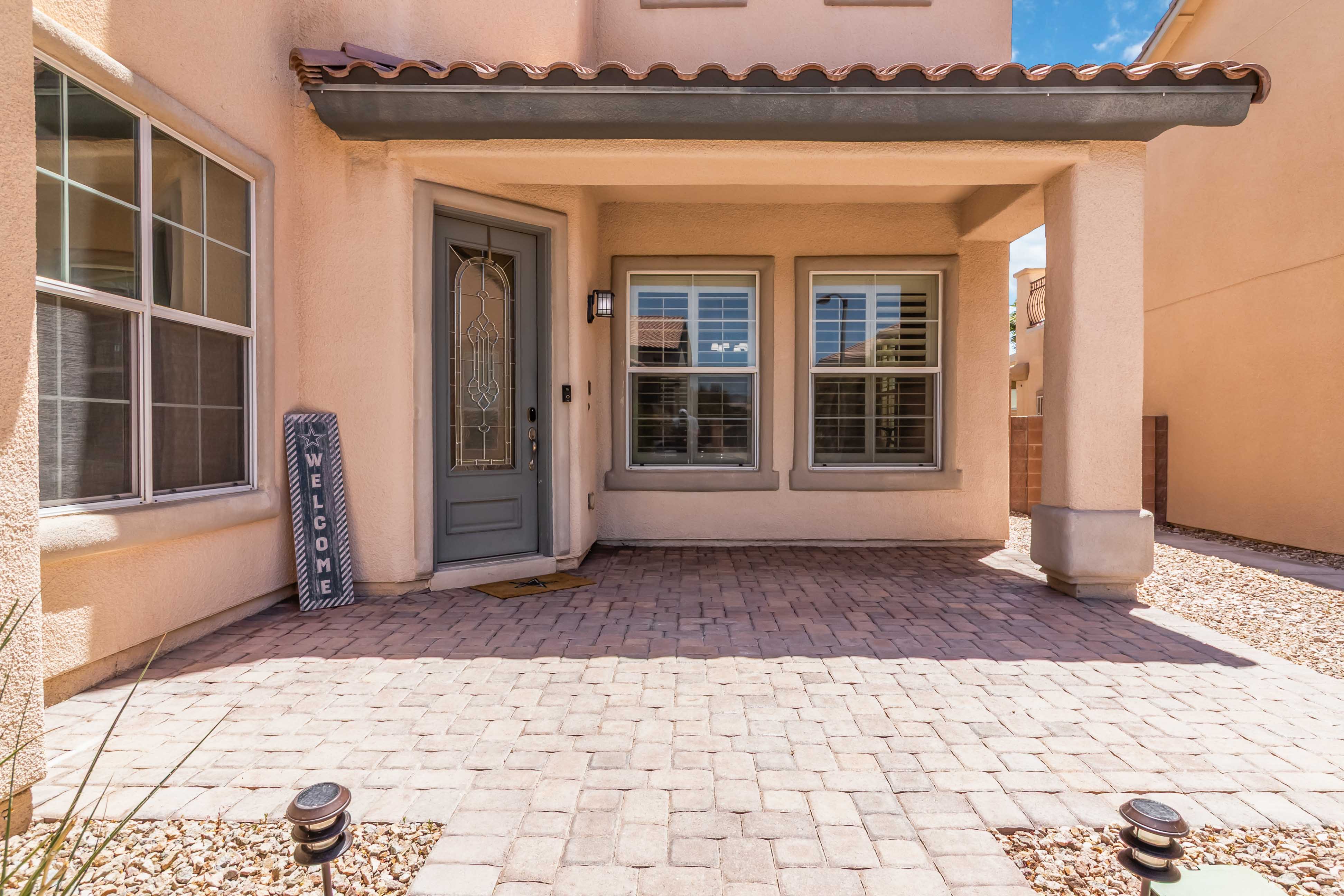 Front porch seating and entry detail at 9564 Trattoria Street