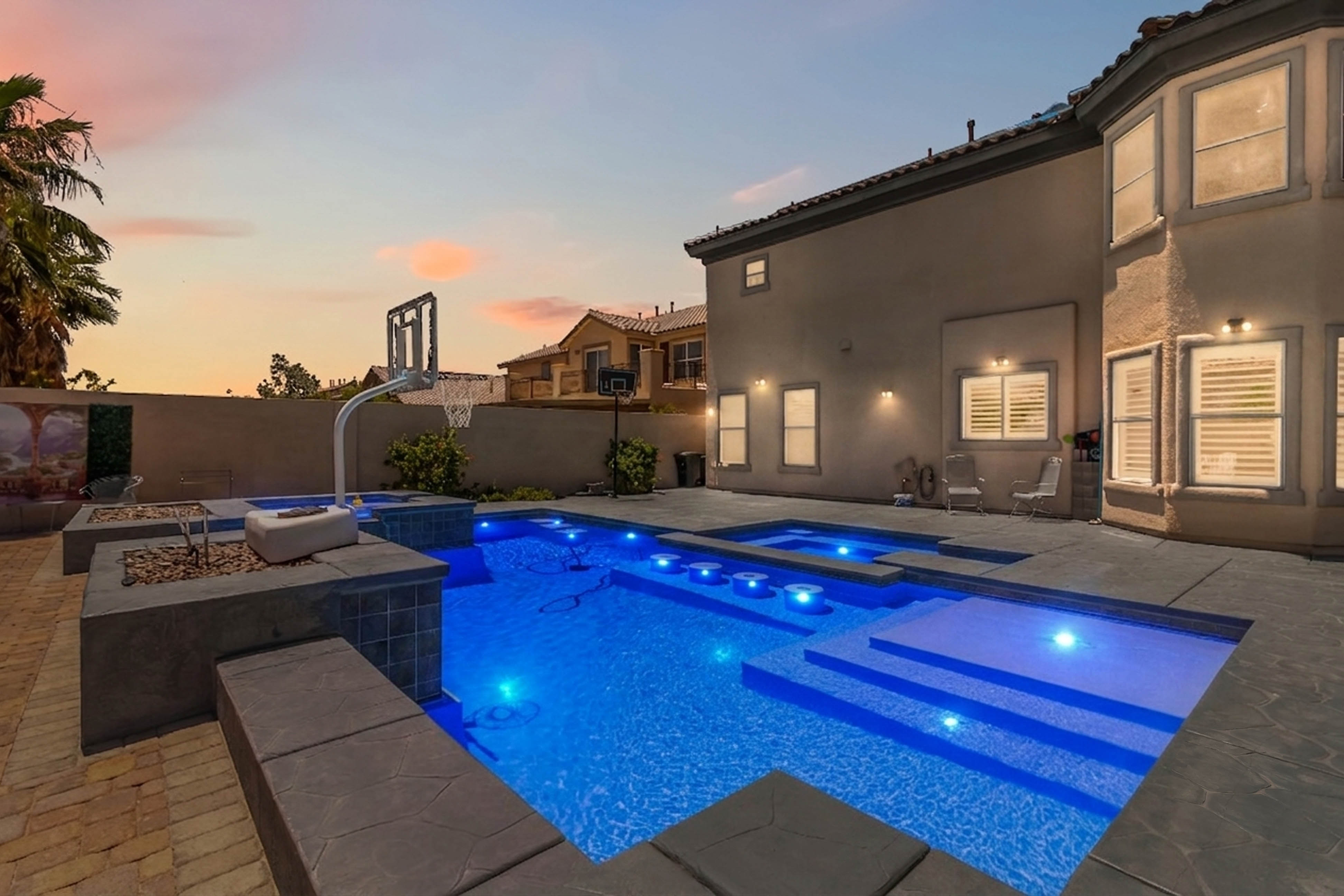Wide backyard view at 9564 Trattoria Street with modern pool design and lounge areas