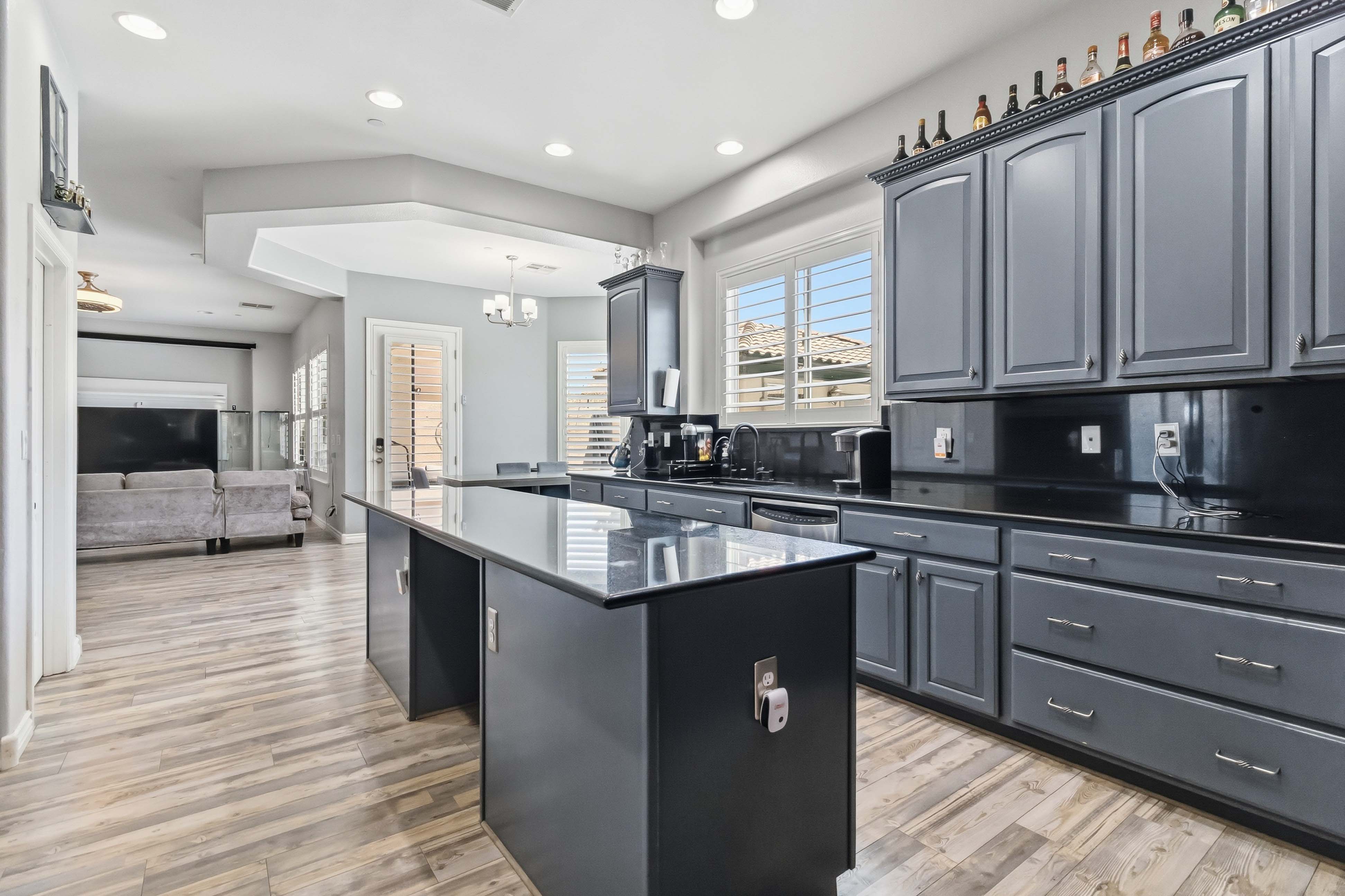 Kitchen at 9564 Trattoria Street opening to the family room and patio access