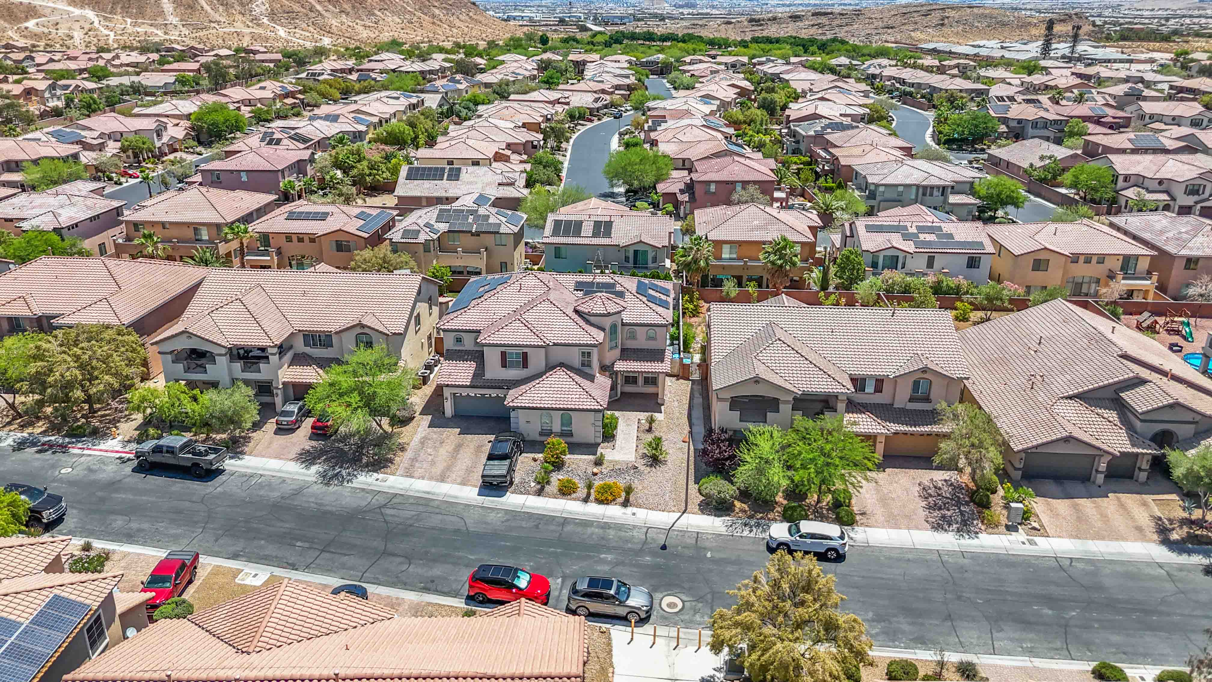Aerial above the rear lot at 9564 Trattoria Street showing the backyard footprint and neighboring homes