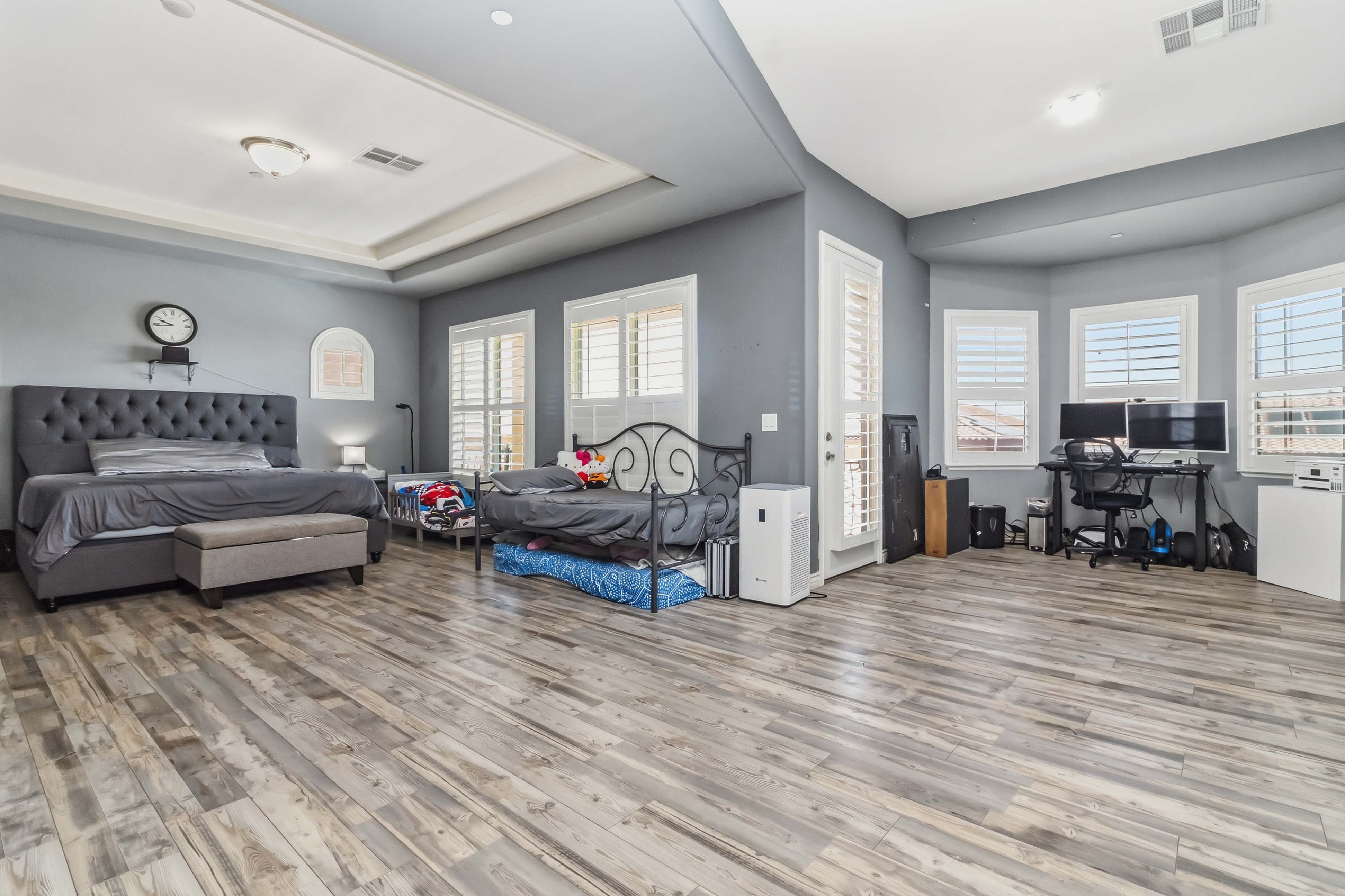 Large upper-level primary suite at 9564 Trattoria Street with sitting area and balcony access