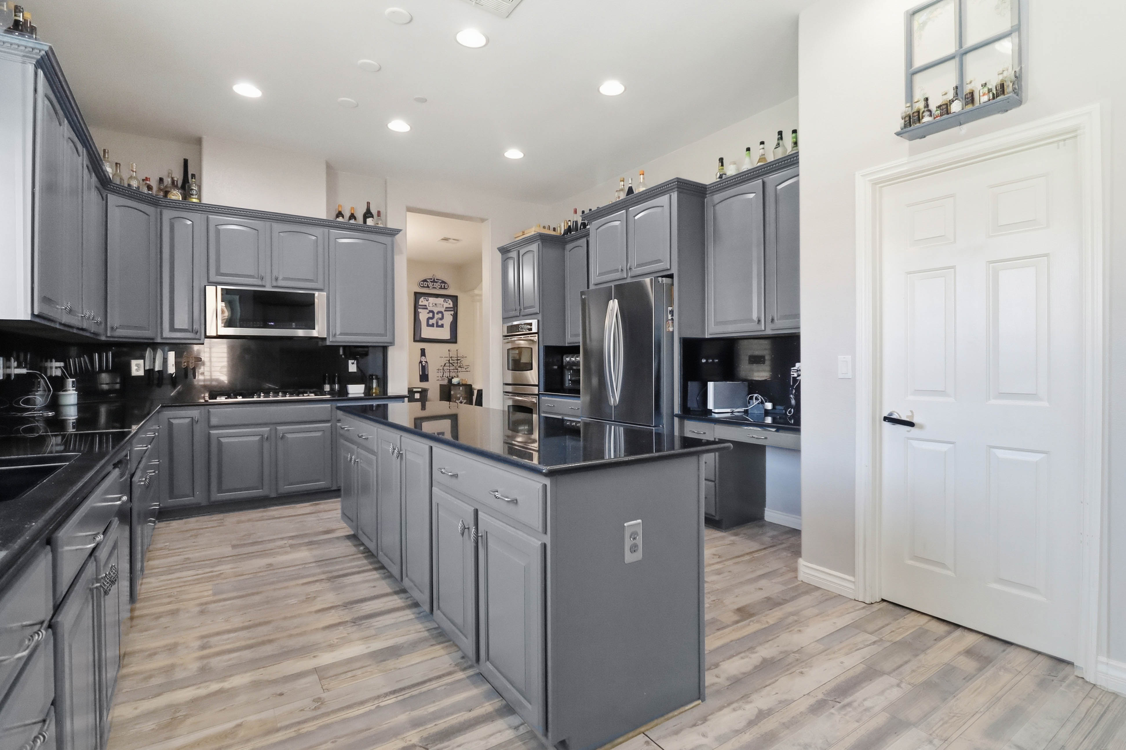Kitchen island and double oven area at 9564 Trattoria Street