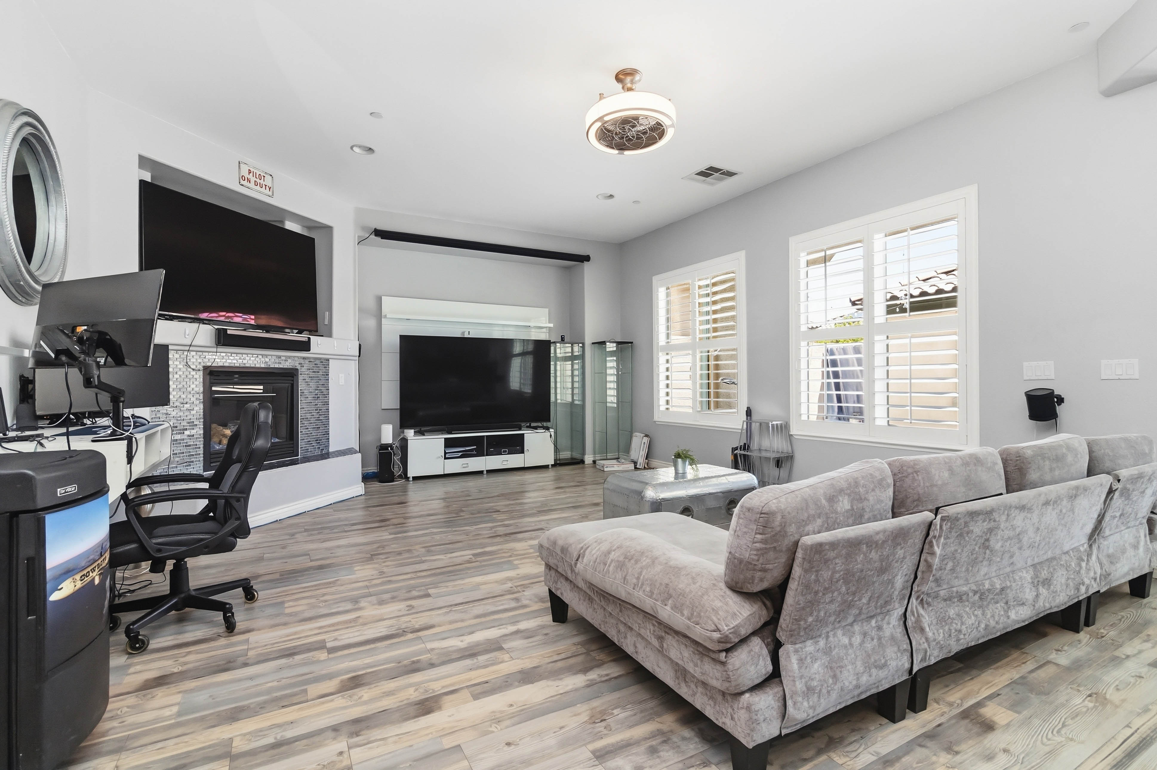 Great room at 9564 Trattoria Street with fireplace, large windows, and lounge seating