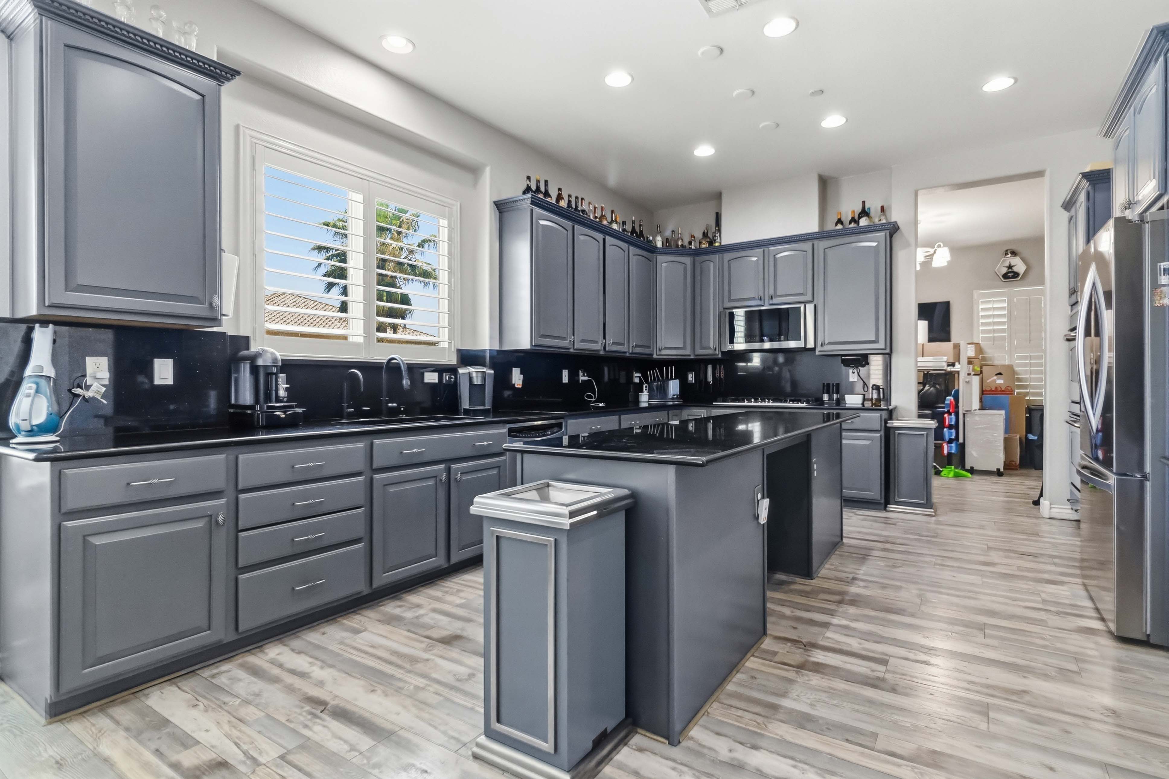 Chef-inspired kitchen at 9564 Trattoria Street with dark cabinetry and oversized island