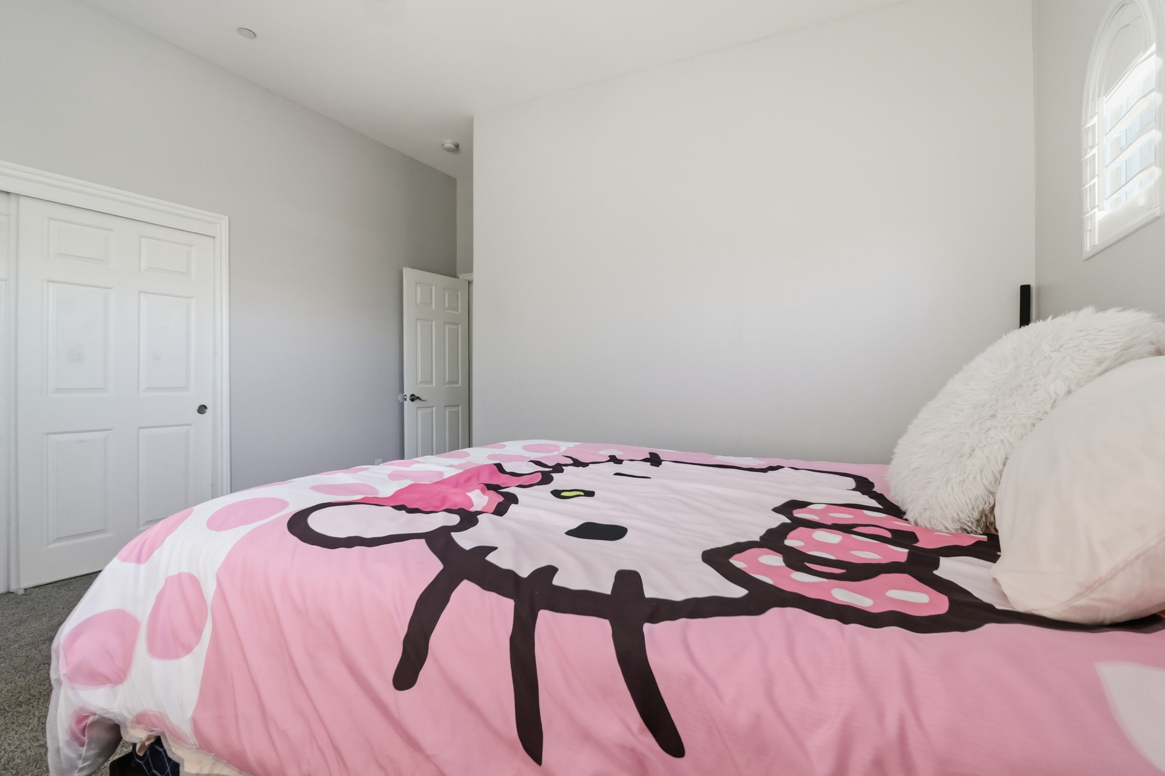Additional bedroom at 9564 Trattoria Street with mounted television and plush carpet
