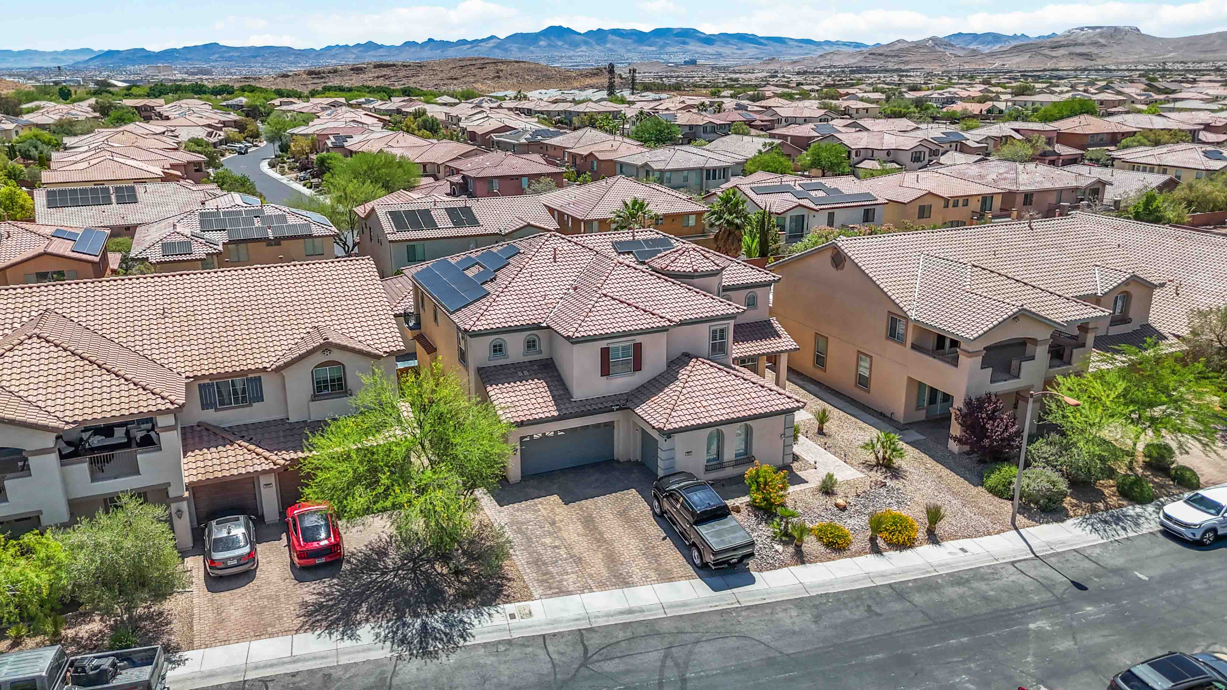 Front-facing aerial of 9564 Trattoria Street with panoramic mountain views