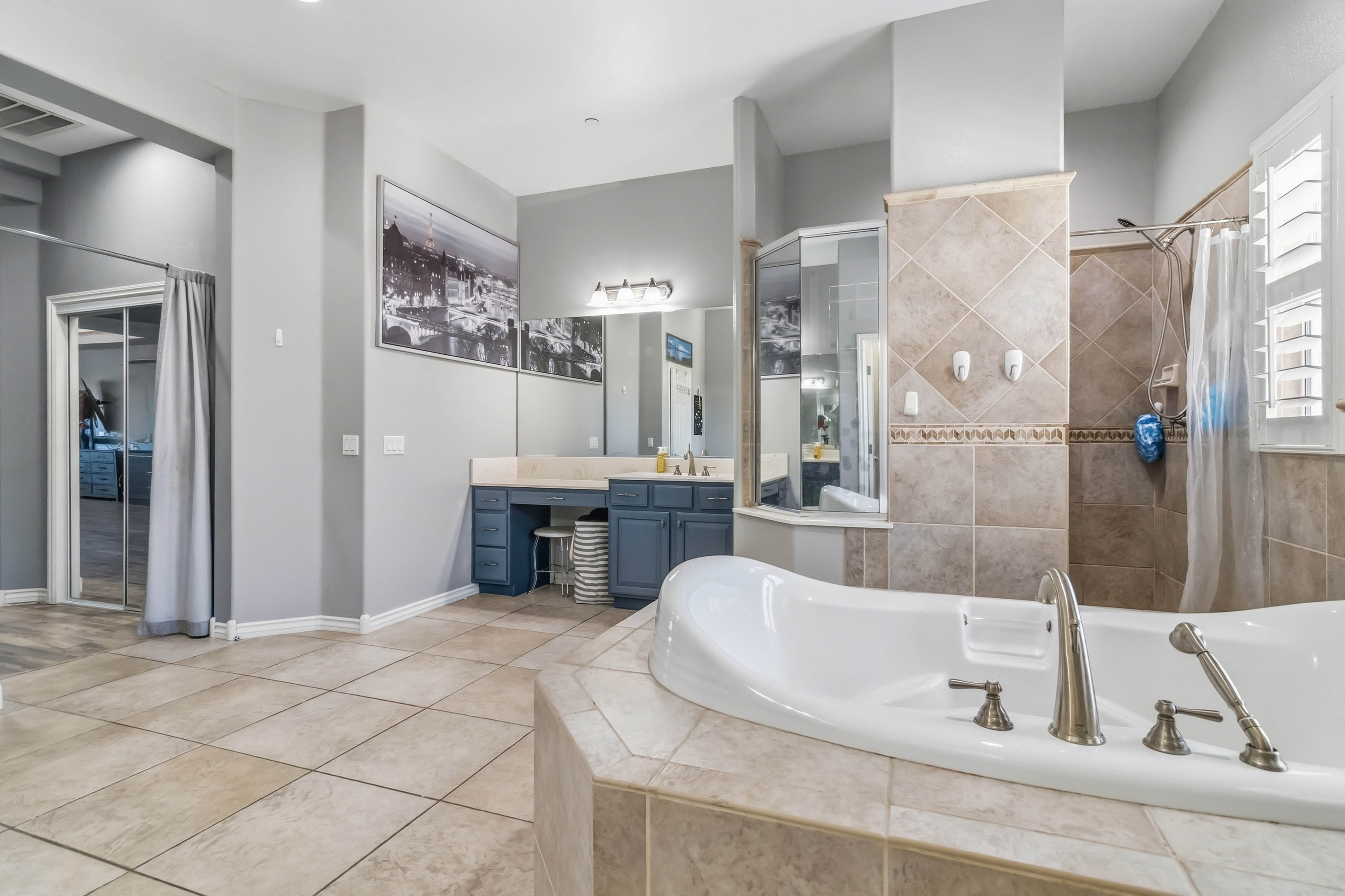 Secondary full bathroom at 9564 Trattoria Street with blue vanity and tub shower