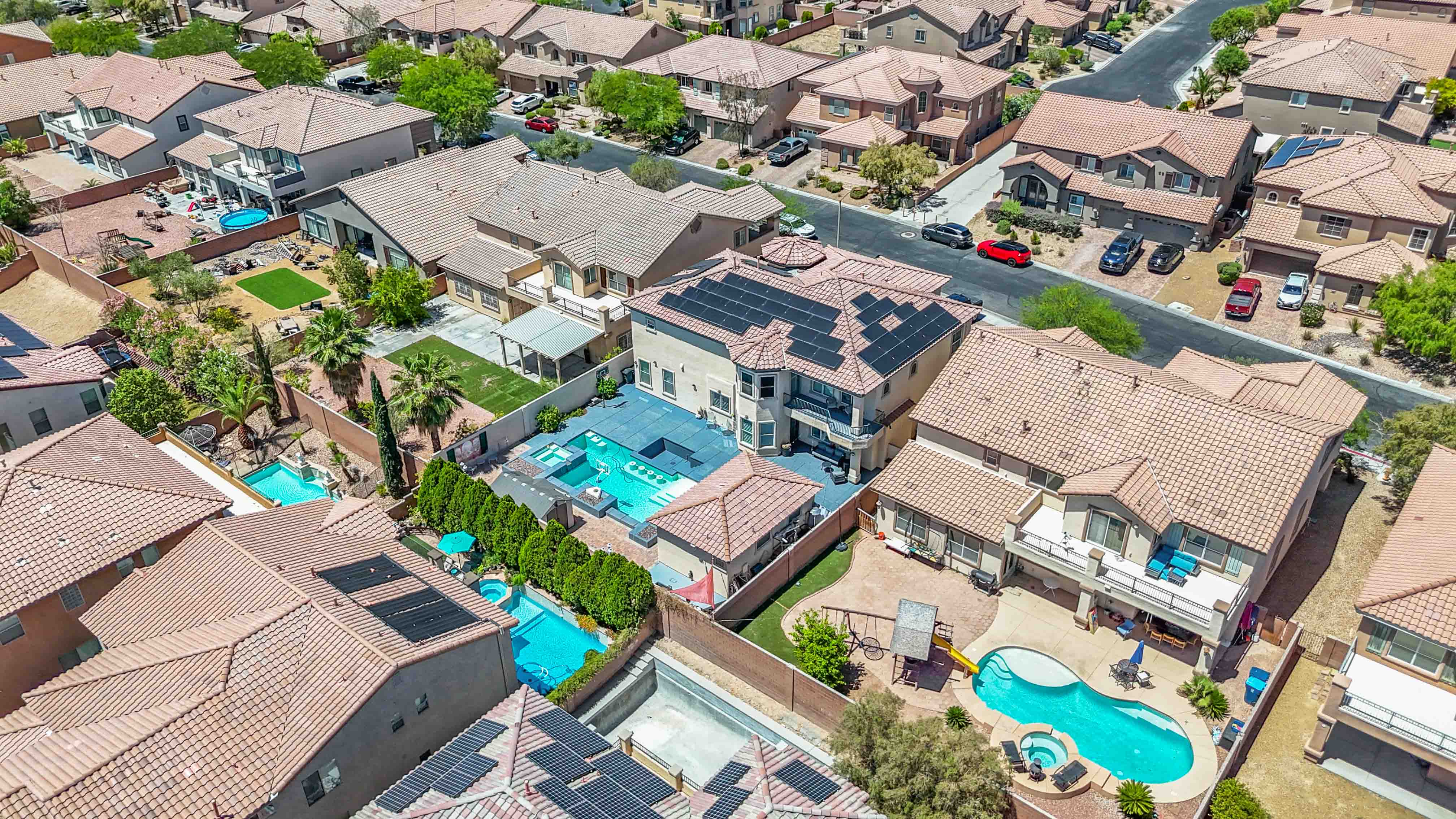 Aerial perspective above 9564 Trattoria Street focused on the pool and rear yard