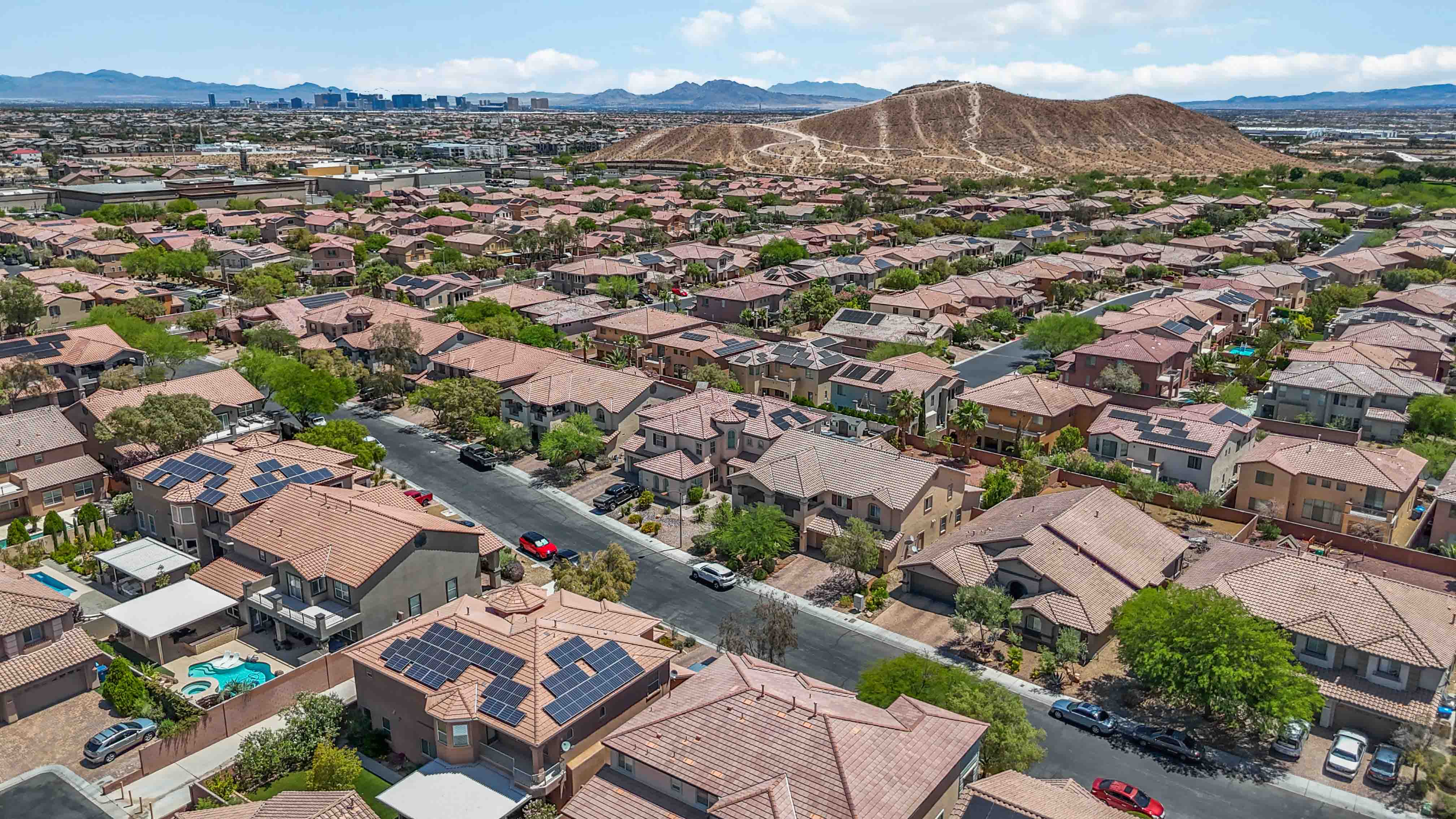Wide community aerial near 9564 Trattoria Street with mountains and Las Vegas skyline in the distance