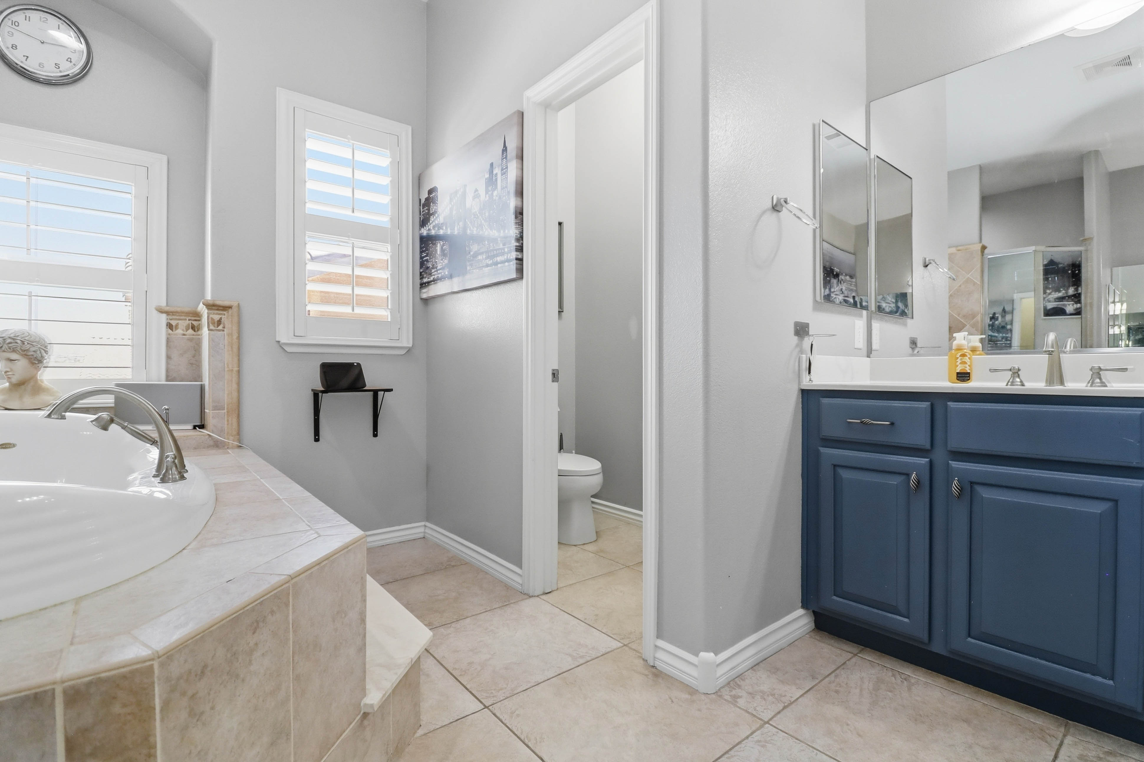 Bedroom and workspace combination at 9564 Trattoria Street with high ceilings