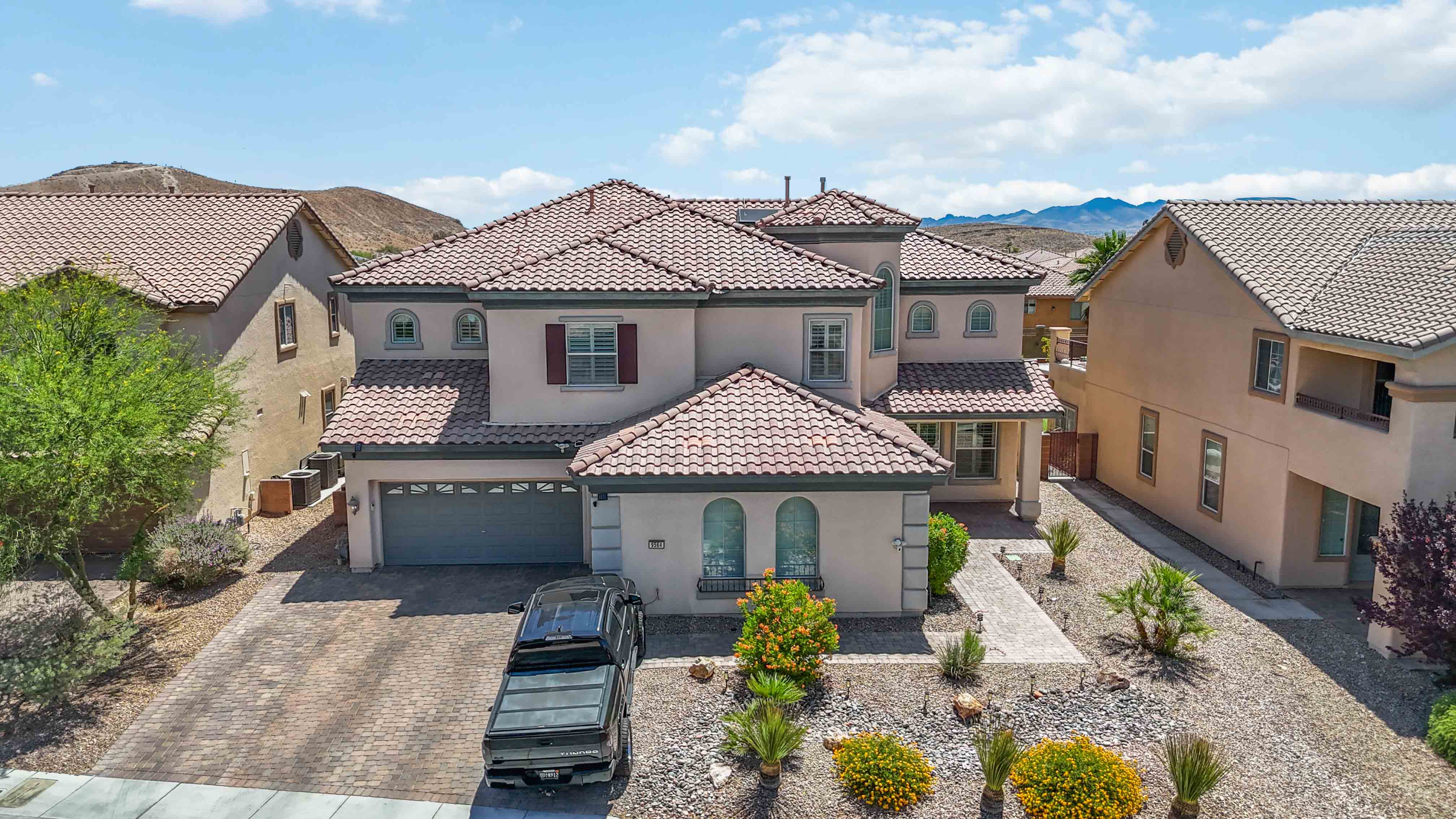 Neighborhood and rooftop aerial near 9564 Trattoria Street with mountain backdrop