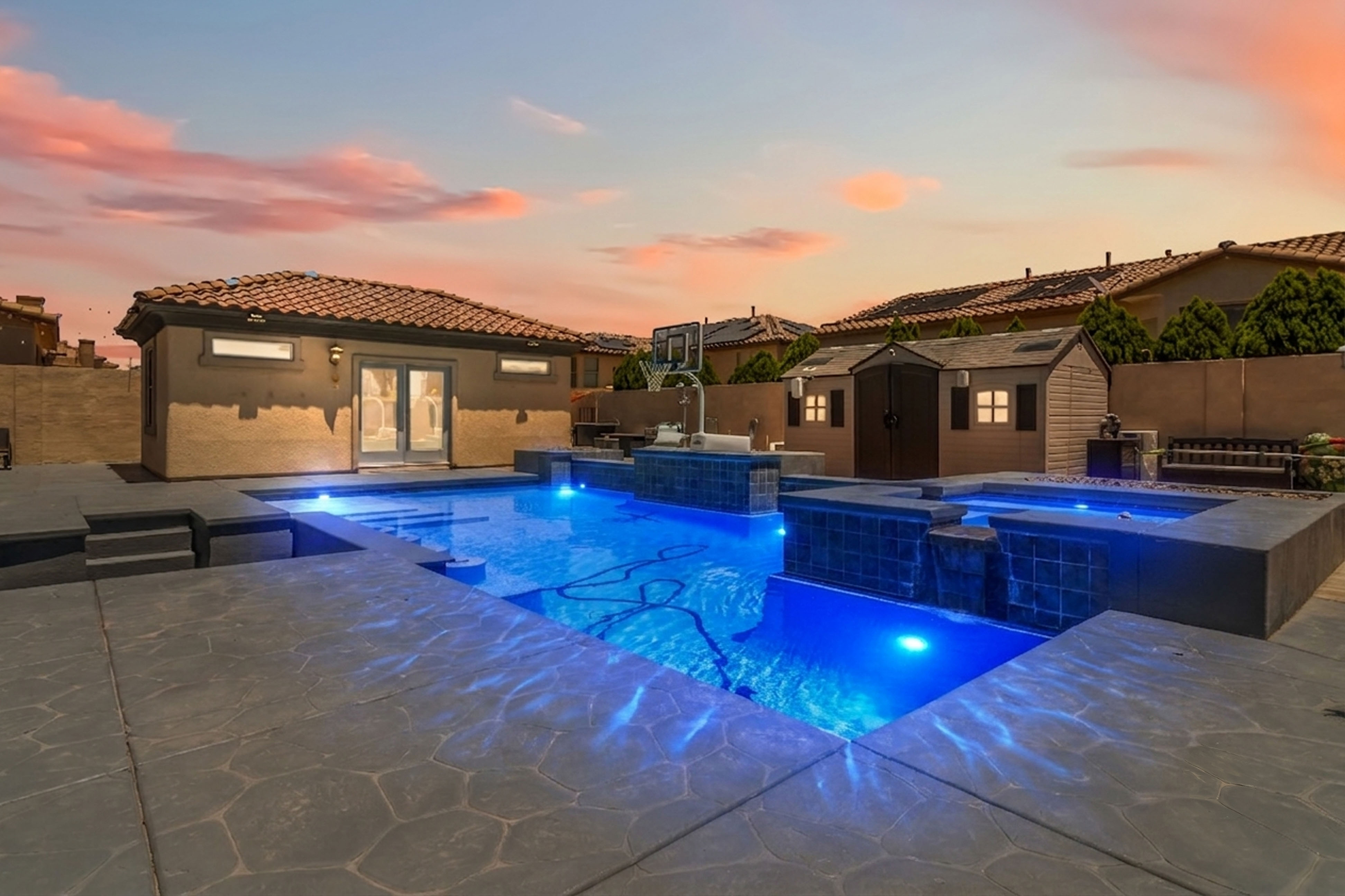 Poolside view of the backyard retreat at 9564 Trattoria Street