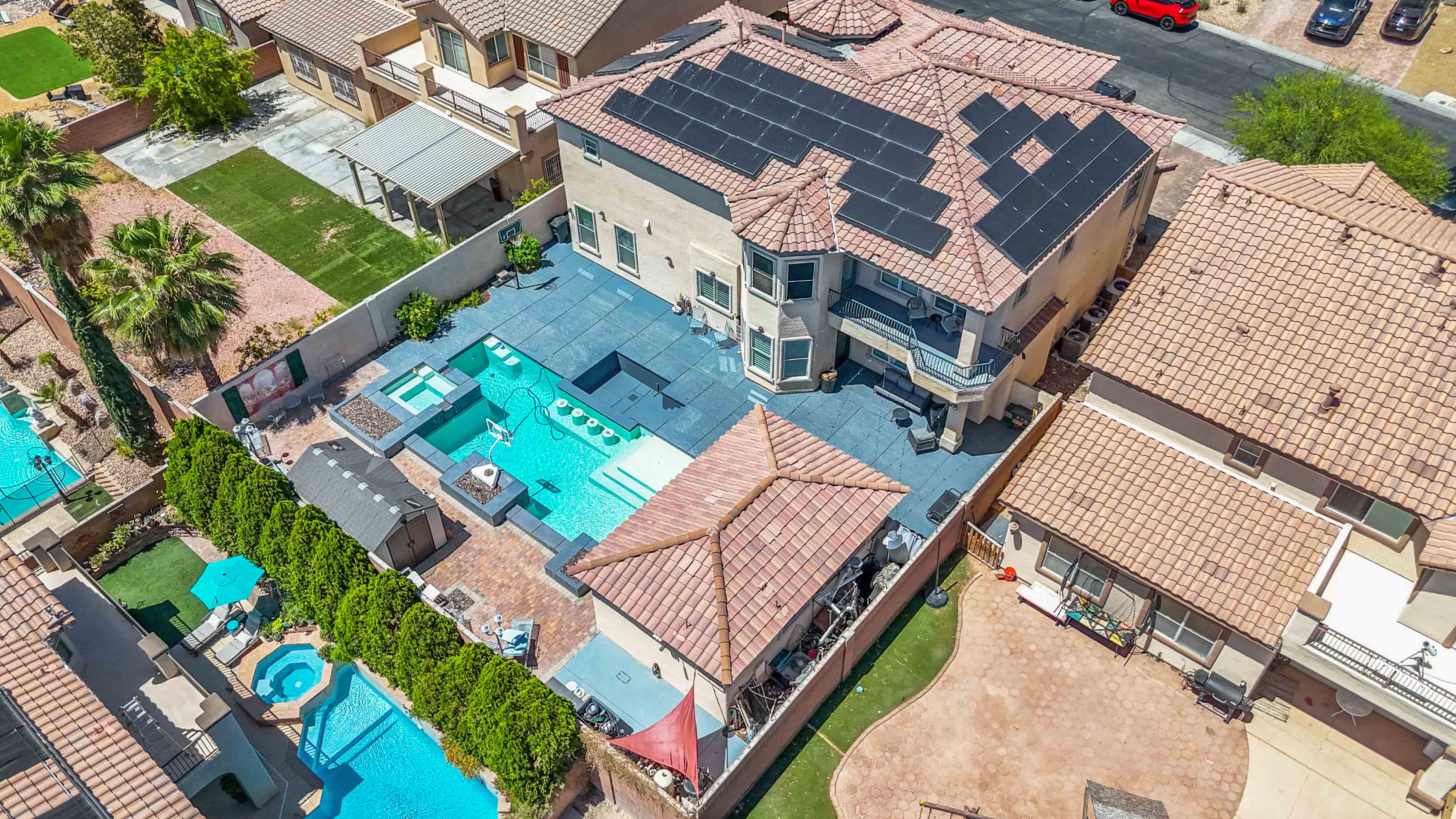 Rear aerial perspective of 9564 Trattoria Street showing the lot orientation and adjacent homes